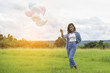 © sunti - Happy beautiful young woman standing holding colorful of balloon