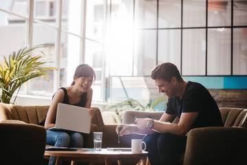 two businesspeople having meeting in cafe