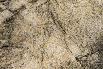 Stone background, rock wall backdrop with rough texture. Abstract, grungy and textured surface of stone material. Nature detail of rocks.