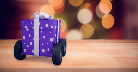 Poster - Composite image of gift box with gray ribbon on wheels 