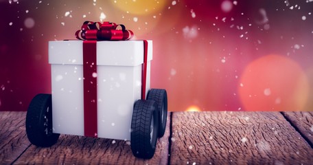Poster - Composite image of gray gift box with wheels