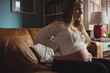 © Wavebreak Media - Pregnant woman relaxing in living room