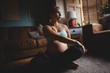 © Wavebreak Media - Pregnant woman performing stretching exercise in living room