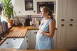 © Wavebreak Media - Pregnant woman drinking water in kitchen