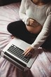 © Wavebreak Media - Pregnant woman using laptop in bedroom
