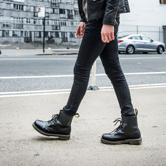 Men fashion concept. Man wear black stylish leather boots and walk outdoors. 