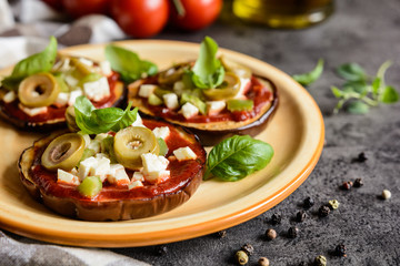 Wall Mural - Eggplant pizzas with tomato sauce, cheese, pepper and olives