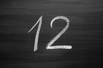Wall Mural - number twelve enumeration written with a chalk on the blackboard