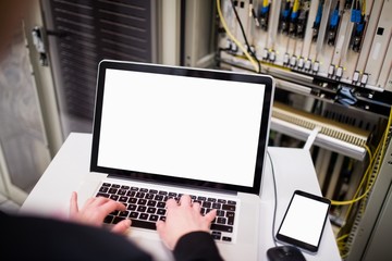 Poster - Technician using laptop while analyzing server