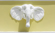 Head elephant statue on yellow wall.