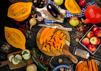 Wall Mural - Autumn vegetables and fruits on a dark wooden background.