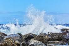 Waves Breaking In Splashes On The Coastal Rocks