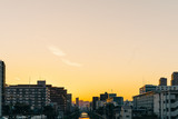 Fototapeta Miasto - City at riverside at sunset