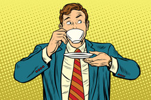 Businessman Drinking Cup Of Coffee Looking Sideways