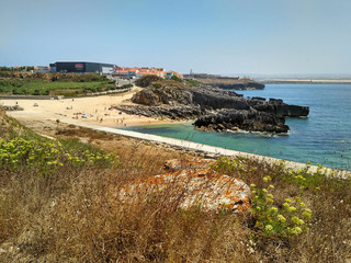 Wall Mural - Coastline with beach and buildings near Cabo Carvoeiro in daylight, Peniche