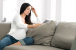 © Eric Hood - Pregnant Woman Lounging with Digital Tablet