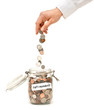 © Eric Hood - Woman Dropping Coins into Glass Jar Labeled Retirement isolated on White background