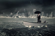 © Creativa Images - Entrepreneur holds umbrella on the boat