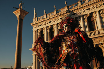 A view from below on a person dressed in rich carnival costume p