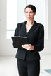 © Eric Hood - Businesswoman with Digital Tablet Computer in Modern Office