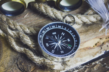 compass rope and other items on the wooden background