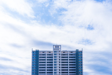 Wall Mural - Real estate image, tower apartment building against blue sky