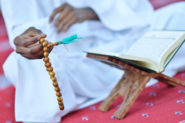 Wall Mural - African Muslim Man Making Traditional Prayer To God While Wearing A Traditional Cap Dishdash