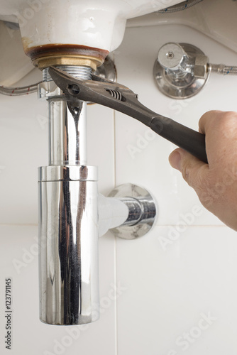 Plumbers Hand With Wrench Tightens Up Under Sink Pipe Buy