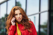 © ZoomTeam - beautiful girl in red coat speaks by phone on the street