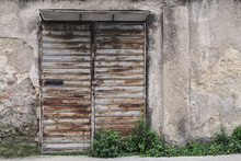 The Front Door Of An Abandoned Shop. Ruins, Decay, Loneliness. Grunge Colors.
