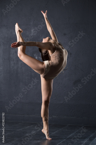 Fotografie, Obraz Refined woman dance in studio at dark wall