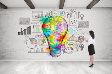 Girl with long black hair looking at light bulb sketch