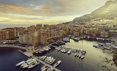 Panoramic view of Port de Fontvieille in Monaco. Azur coast. Colorful bay with a lot of luxury yachts in sunset.