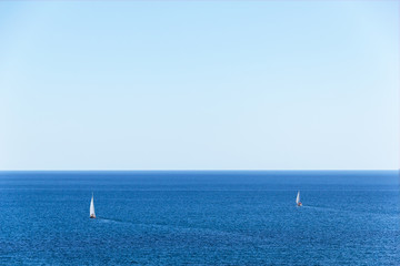 Two yachts on the high seas.