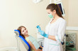 © Saksoni - attractive woman dentist with girl patient