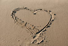 Cute Hearth Shape Written In The Sand On The Beach
