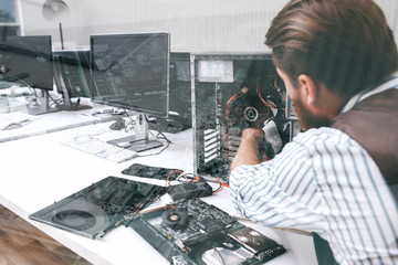 Poster - Electronic repairman working with CPU, double exposure. Unrecognizable engineer disassembling computer unit in repair shop