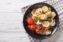 Delicious Tortellini With Ham, Tomatoes And Cheese Close-up.  Horizontal Top View
