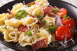 Italian food: tortellini with prosciutto and parmesan close-up on a plate. Horizontal
