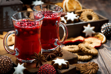 Christmas drink hot cranberry tea and cookies on dark background