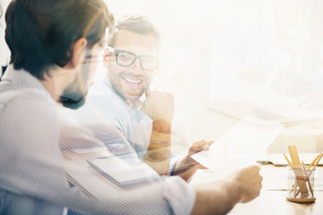 Wall Mural - Smiling man during business meeting with his partner