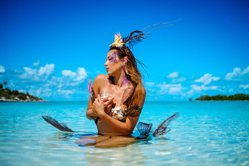 Portrait of exotic fantasy mermaid in blue ocean