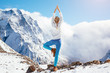 Yoga on mountain in winter
