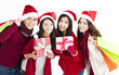 © Tom Wang - Happy young group  in santa hat and shopping together
