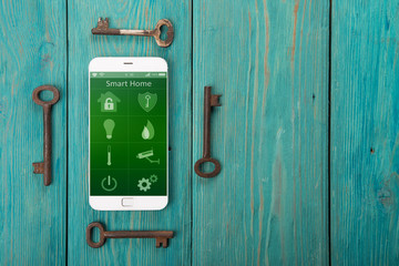 Wall Mural - Smartphone with smart home app on the wooden desk