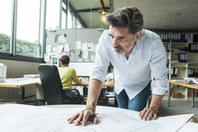Architect working on ground plan in office