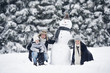 © Westend61 - Family posing at snowman