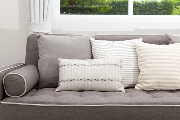 Detail of modern living room with beige pillow cushions on sofa