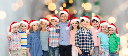 Poster - happy smiling children in santa hats hugging