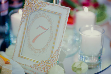 Wall Mural - Table number put in a white frame with golden design